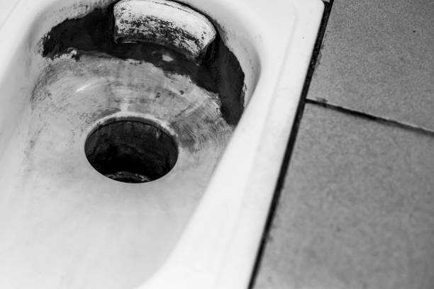 istock an old public floor-standing toilet, with broken tiles and rust. foreground and background blurred with bokeh effect 1340452566