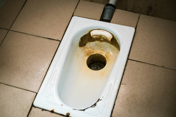 istock an old public floor-standing toilet, with broken tiles and rust. foreground and background blurred with bokeh effect 1340452568