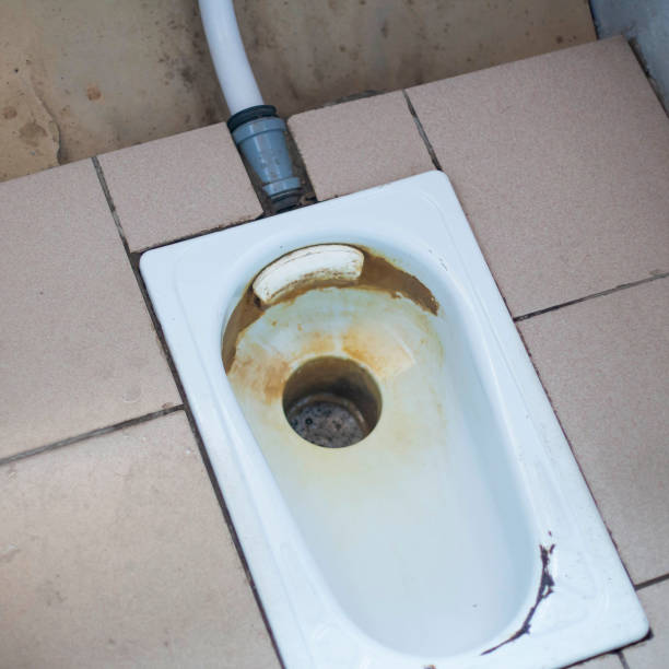 istock an old public floor-standing toilet, with broken tiles and rust. foreground and background blurred with bokeh effect 1340452588