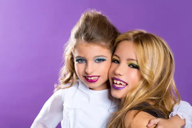 children two fashiondoll kid girls good friends with fashion makeup on purple