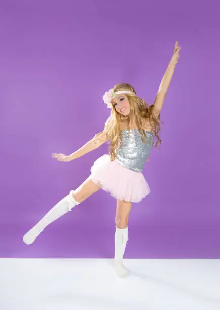 Children fashiondoll spring girl dancing on purple background