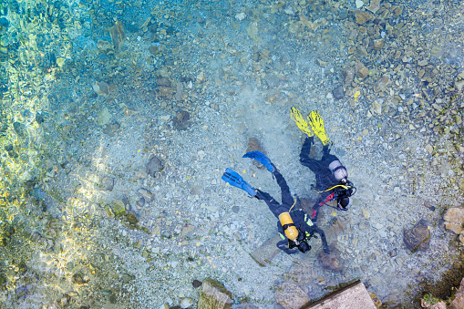Female scuba diver on the wreck of the Iona ship in the red sea offshore from Yanbu, Saudi Arabia