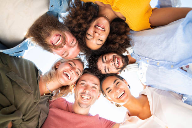 istock Multicultural group of friends in circle - Multi-ethnic young people taking selfie smiling at camera - Teamwork, friendship, community, university and human resources concept 1340457761