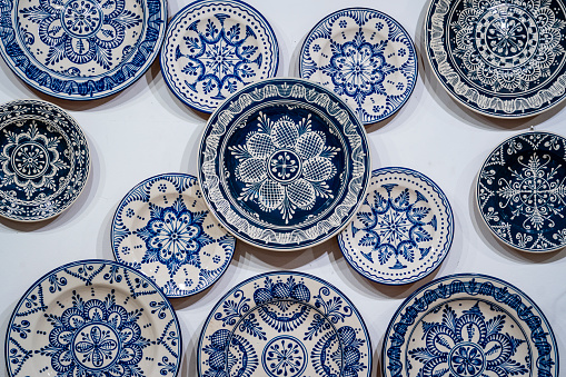 Traditional Hungarian porcelain handmade in blue paint on a white wall at a street market in the ethnographic village of Holloko in Hungary