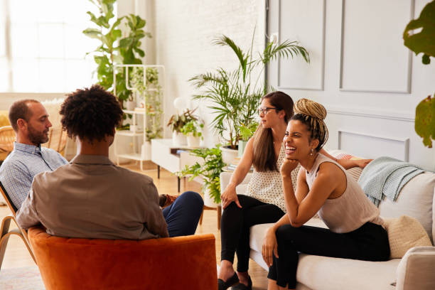 istock Smiling group of businesspeople talking while sitting in an office lounge 1340461239