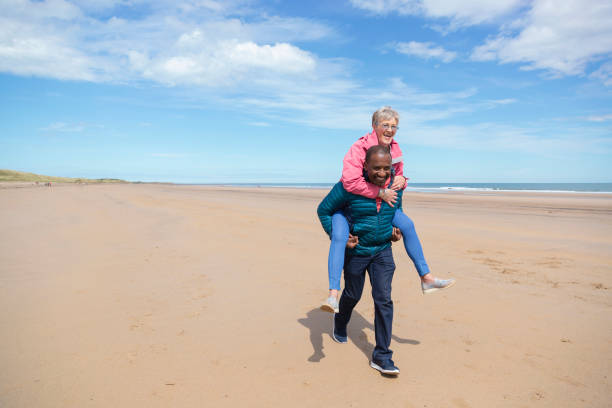 istock Senior Couple Having Fun on the Beach 1340462919