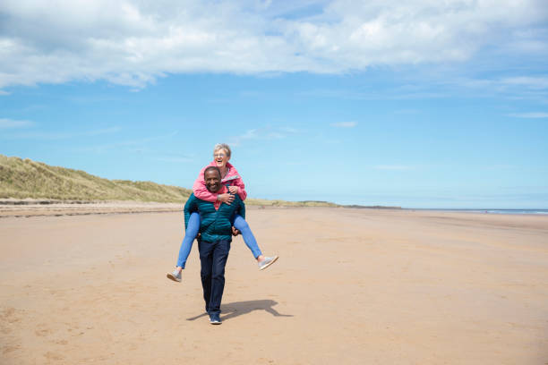 istock Multiracial Senior Couple Having Fun on a Beach 1340462930
