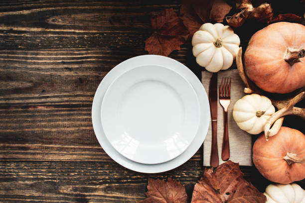 Holiday place setting with plate, napkin, and silverware on a Thanksgiving Day stock photo