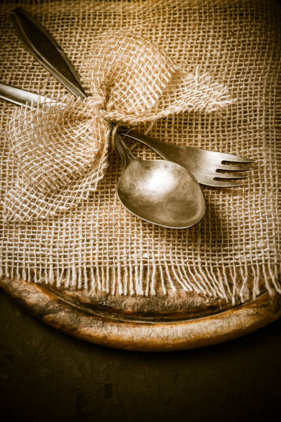 istock Vintage tableware, cutlery with wooden cutting board 1340464521