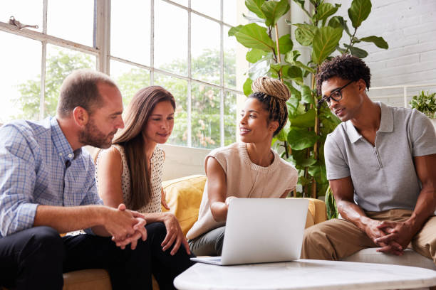 istock Diverse group of smiling businesspeople working together on a laptop 1340464607