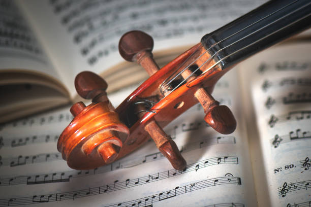 istock Detail of a violin handle resting on a score 1340464638