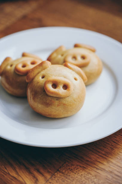 Homemade mooncake in pig design on plate. Mooncake is a traditional Chinese food eaten during the Mid-Autumn Festival