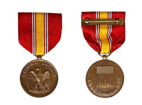 Front and back of a Vietnam War era United States National Defense medal.