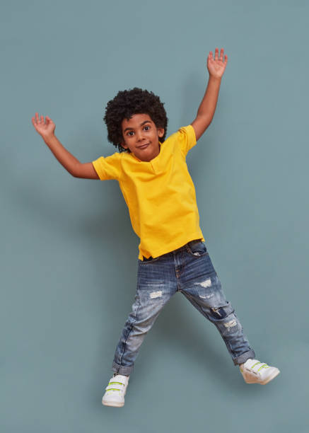 istock Afro-american kid jumping of happiness 1340465981