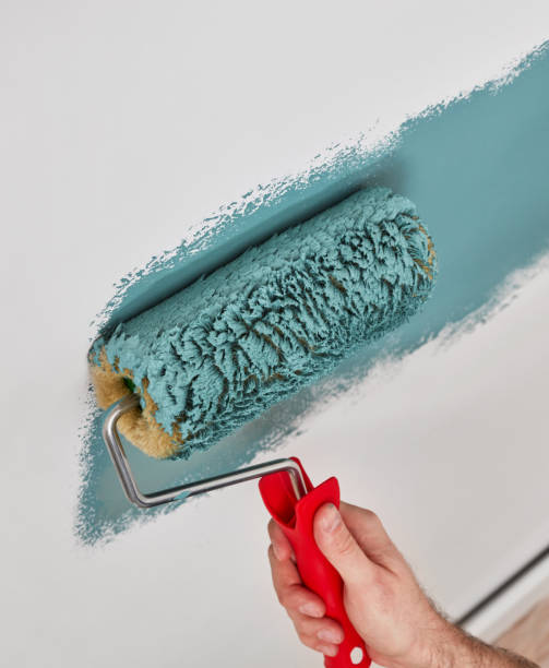 istock Close-up of a paint roller on the wall 1340465998