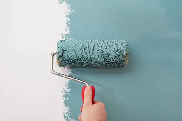 Photo of Close-up of a paint roller on the wall