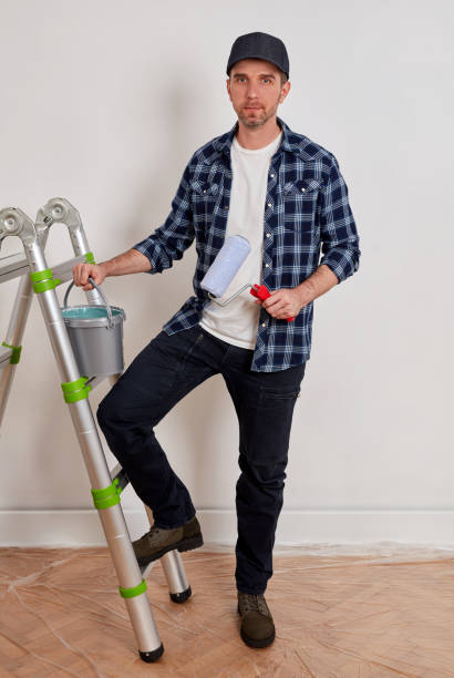 istock House painter with paint bucket and paint roller 1340466026