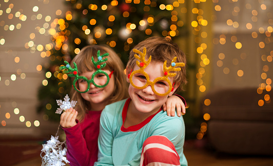 happy kids with party glasses at home near the Christmas tree