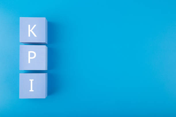 istock KPI letters on light blue cubes against dark blue background with copy space 1340470611