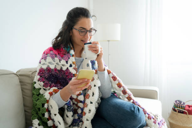 istock Young woman using phone at home 1340470731