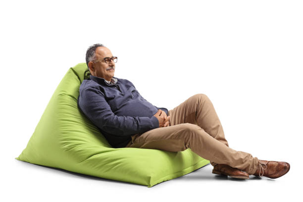 istock Relaxed mature man sitting on a green bean bag chair 1340472111