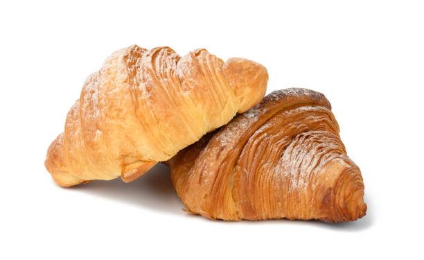 istock two baked croissants on a white isolated background, dessert for breakfast sprinkled with powdered sugar 1340473606