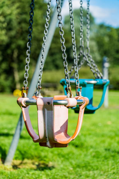 istock Empty colorful swings at the park 1340474857