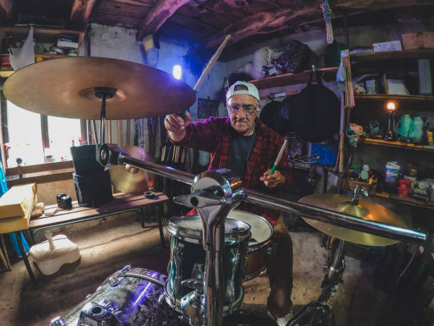 The older man, the older man who practices playing drums in his garage, reminds him of the days when he ruled the stage at concerts.