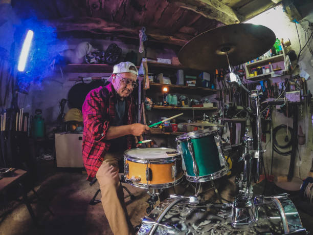 istock An older man practices playing drums in his garage 1340475294