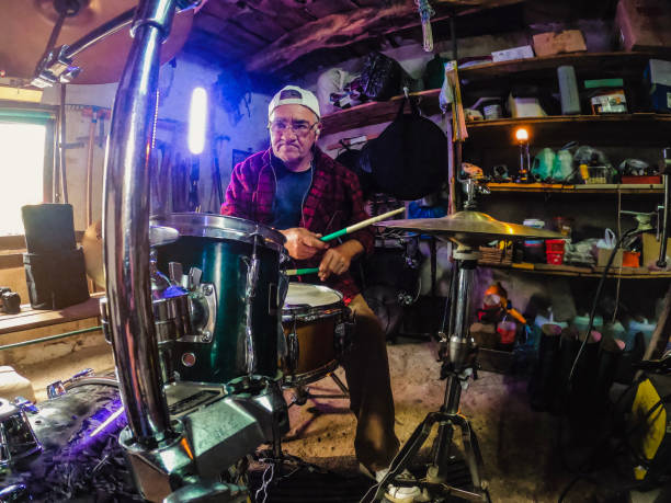 istock An older man practices playing drums in his garage 1340475297
