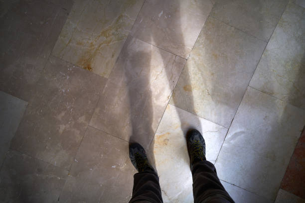 Legs and feet shoes shadow on marble floor flooring background