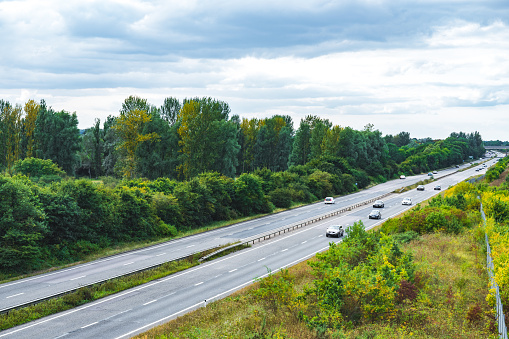 Road with car traffic crossing beautiful country land