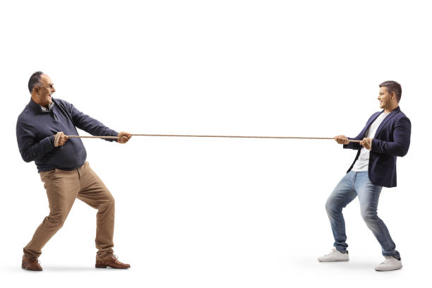 istock Full length profile shot of a a mature man and a young man pulling a rope 1340477425