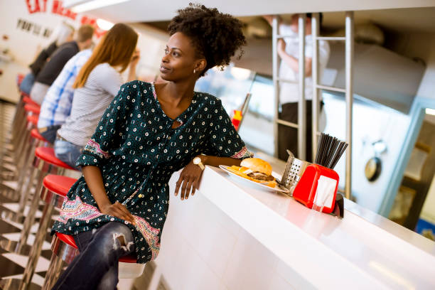 istock Young african american woman in the diner 1340478521