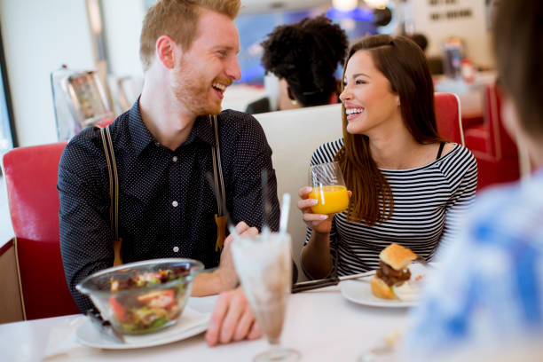 istock Friends eating at the table in the diner 1340478528