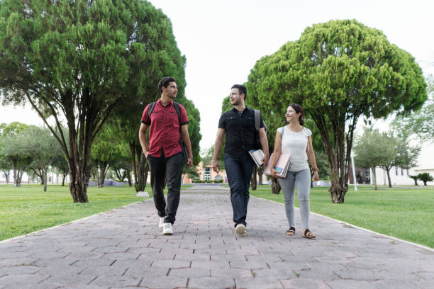 istock Latin university students walking with school things 1340480212