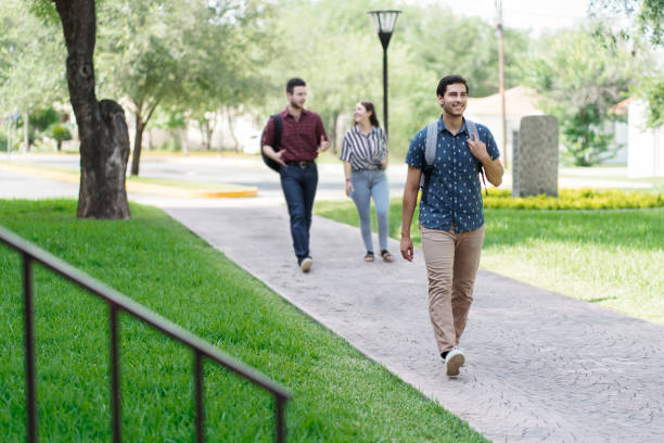 istock Happy latin students walking on campus university 1340480218