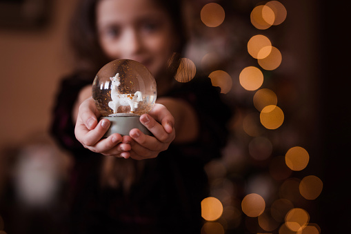 Cute crystal ball held by a young girl