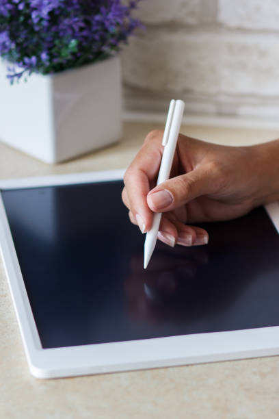 istock Woman drawing with a tablet device 1340480633