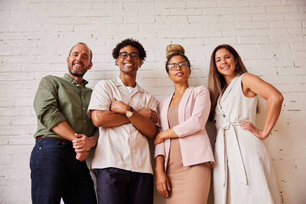 istock Diverse businesspeople smiling while standing together in an office 1340482026
