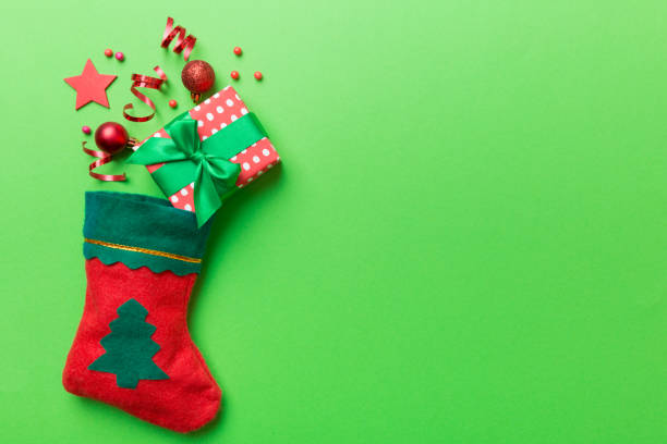 istock santa red sock top view on the color background with empty space. Christmas background 1340483467