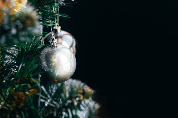 istock Silver ball on Christmas tree on black background 1340491534