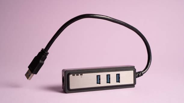 istock Black USB hub isolated on violet. Three ports USB charger 1340495439