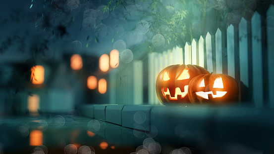 Glowing candle lit Jack O Lantern Halloween pumpkin decorations outside on a street pavement. 3D illustration.