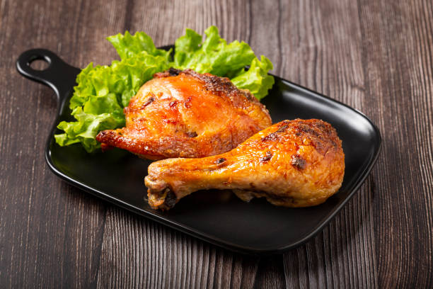 istock Roasted chicken pieces with lettuce salad. 1340499816
