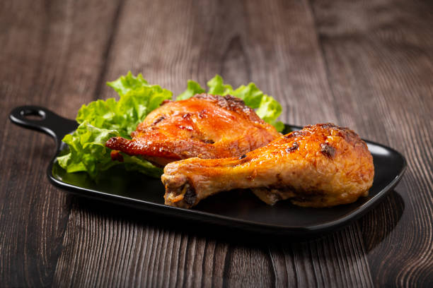 istock Roasted chicken pieces with lettuce salad. 1340499830
