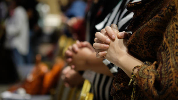 people praying together at church. - rezando imagens e fotografias de stock