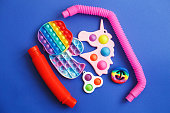 colorful antistress sensory fidget toys on a blue background.