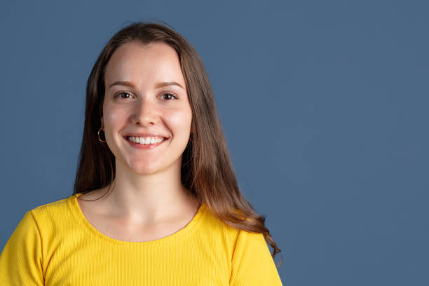 istock One caucasian girl smiling isolated over blue studio background 1340505255