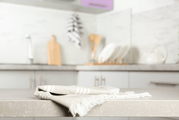 istock Striped cotton towel on light grey table in kitchen 1340505434